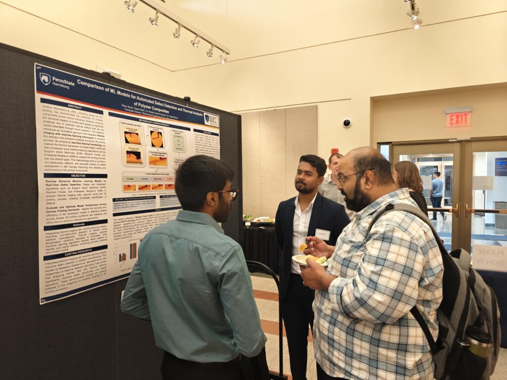 Attendees engage with Dhruv Suraj and Sapan Sahah’s poster on AI-driven defect detection during the 2025 Research Symposium.