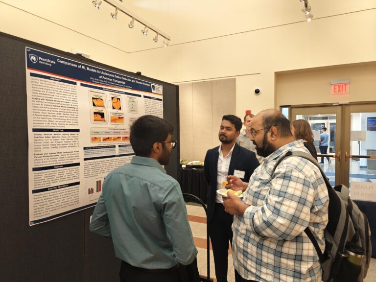 Attendees engage with Dhruv Suraj and Sapan Sahah’s poster on AI-driven defect detection during the 2025 Research Symposium.