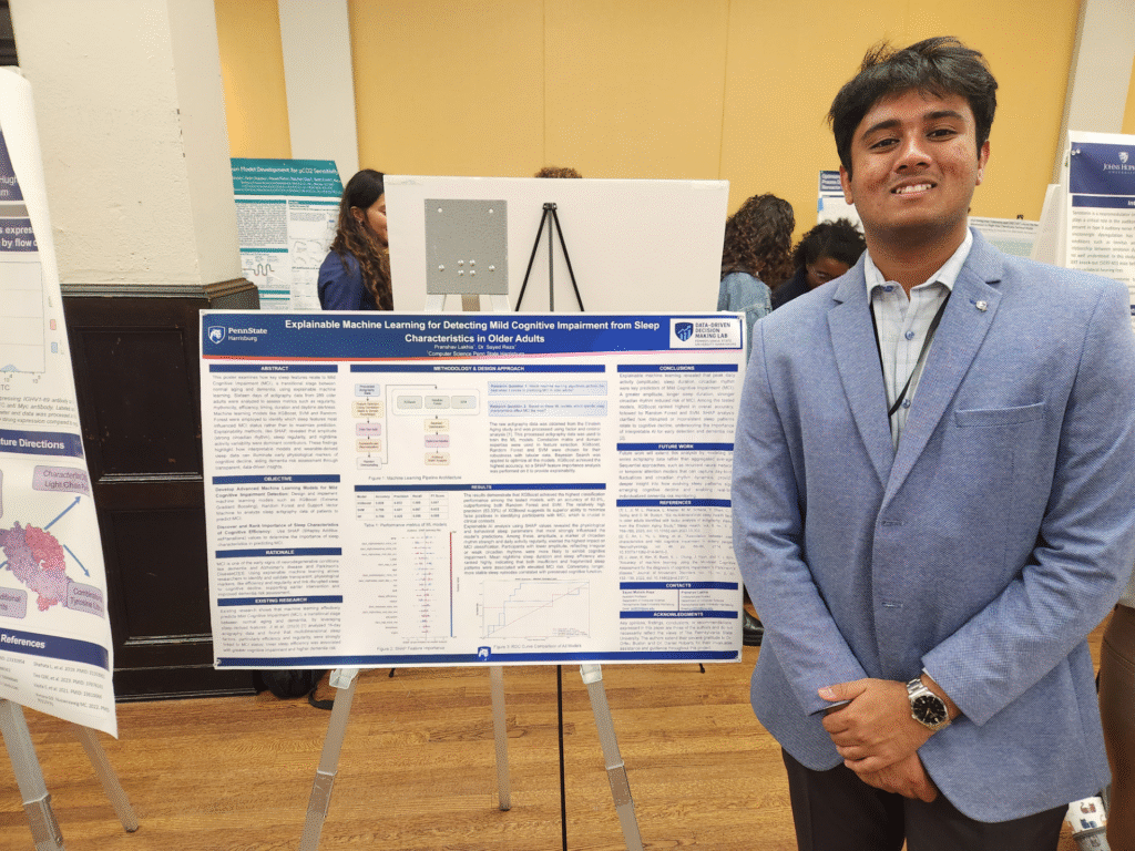 Pranshav is presenting his research poster.