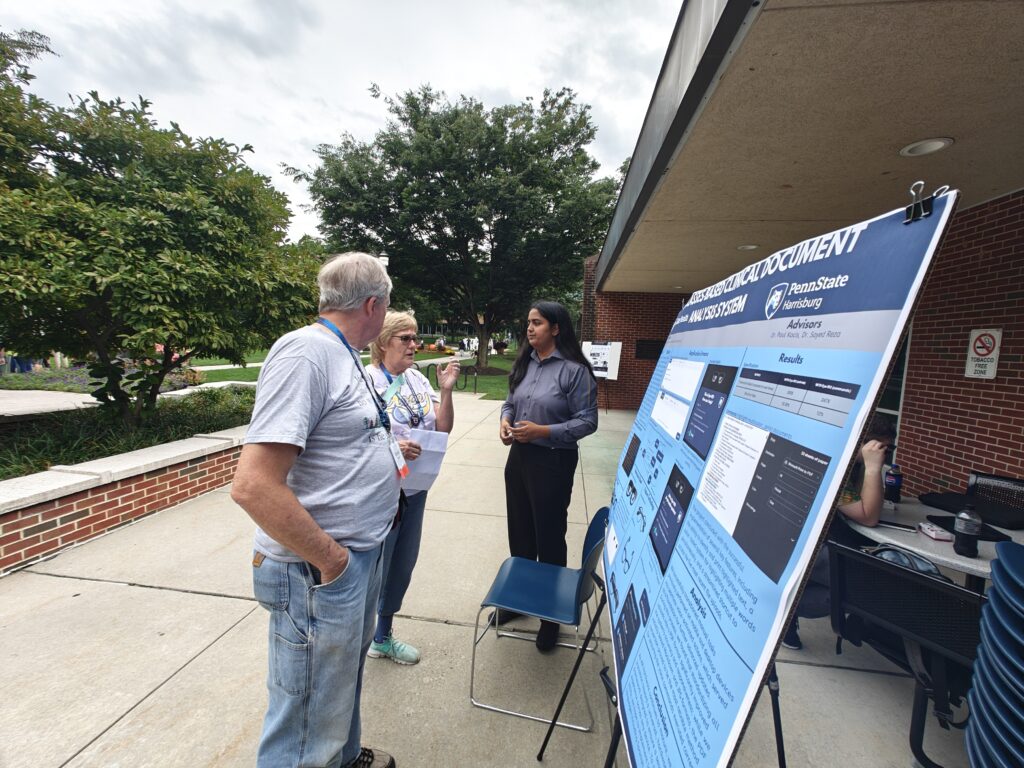Zainab Qazi presents her smart glasses research to visitors during Penn State Harrisburg's 60th Anniversary Celebration